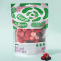 Packaged freeze-dried mixed berries with visible brand logo on a light blue background